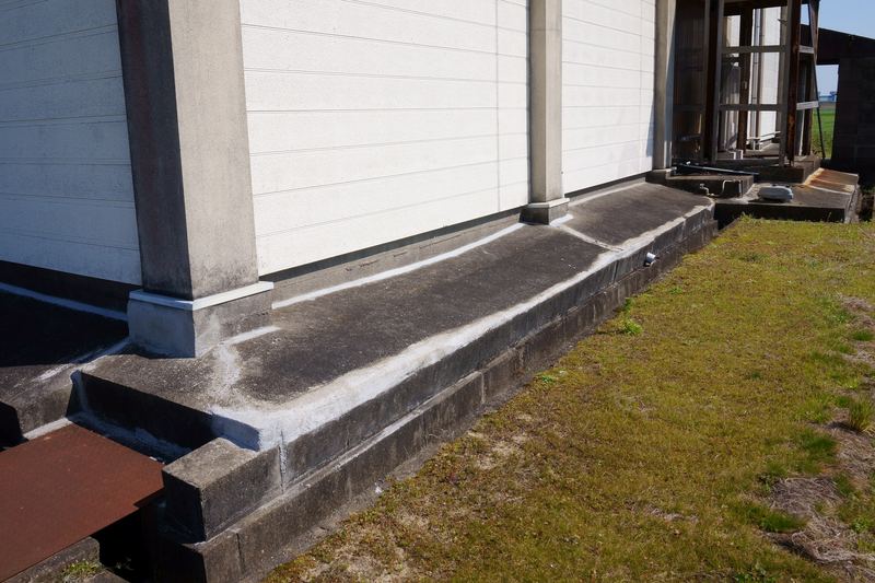 Filled cracks on the building foundation that caused by ground subsidence(it looks like lift the building). An old warehouse in Baba, Kohoku